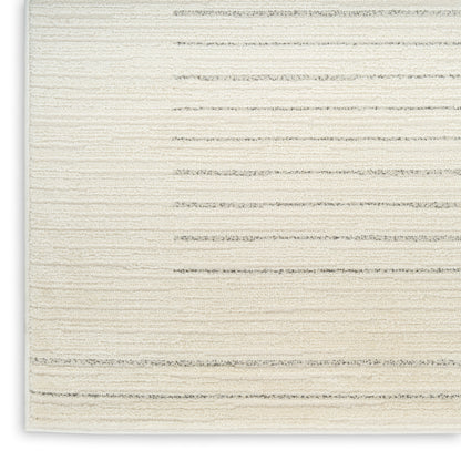 Cream textured rug close-up with pale gray horizontal stripes and soft woven pile.