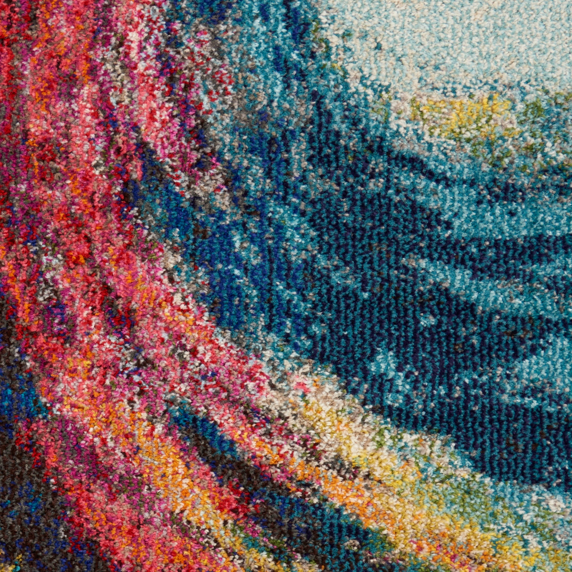 Vibrant multicolor woven rug for home decor, with pink, teal and blue swirls and plush textured pile.