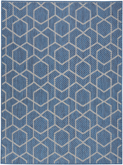 Blue woven rug with white interlocking hexagon lattice pattern; textured geometric decor.