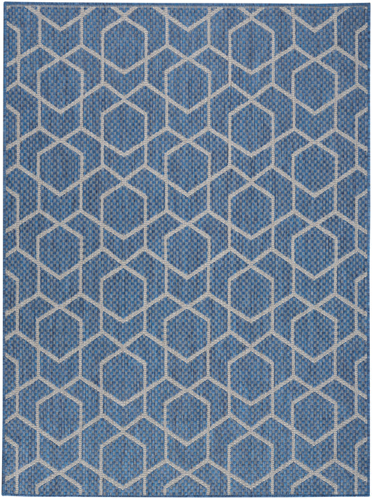Blue woven rug with white interlocking hexagon lattice pattern; textured geometric decor.