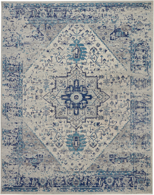 Blue and ivory distressed Persian-style area rug with central medallion and ornate border, versatile living-room accent.