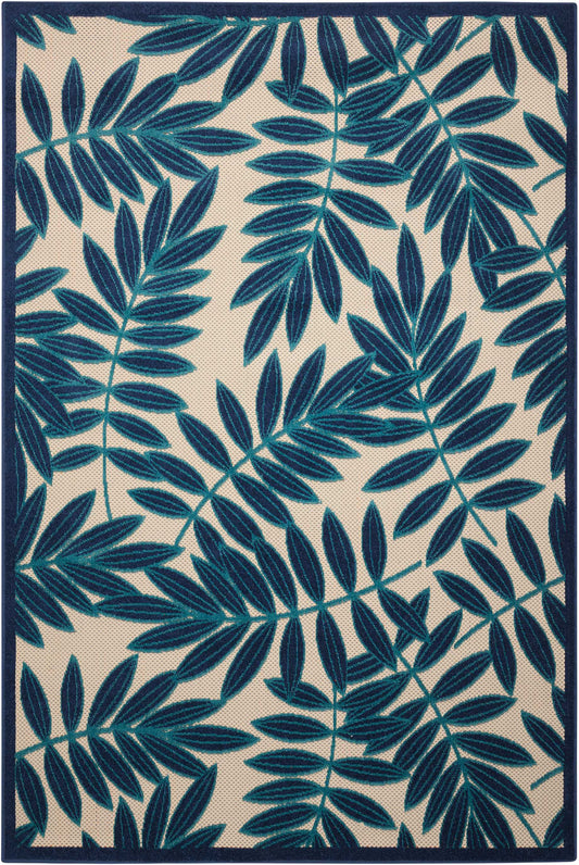 Teal fern leaf pattern rug on cream background with navy border, rectangular area rug.