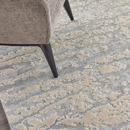 Beige textured rug with an abstract gray-beige pattern.