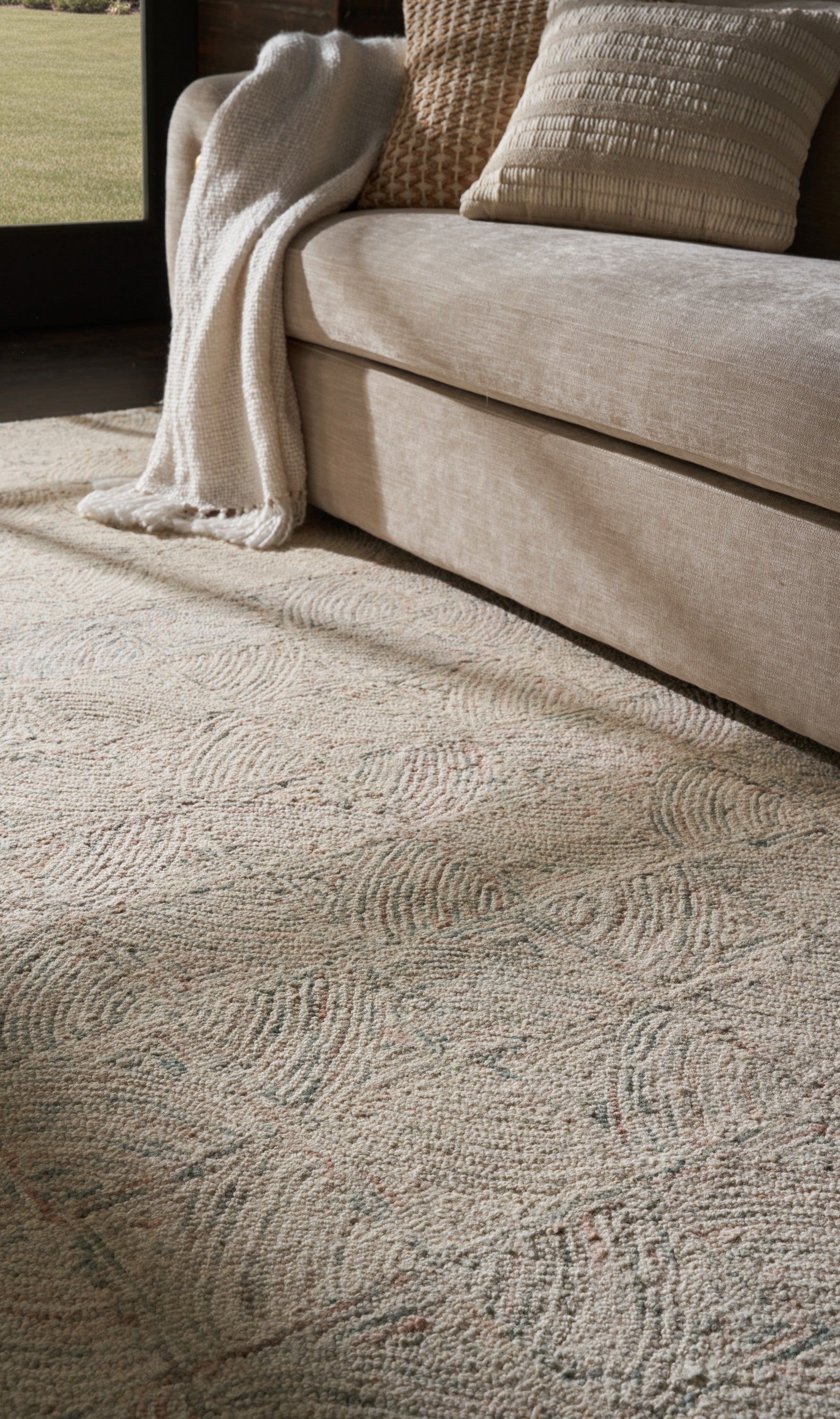 Light patterned beige area rug, 8' x 11'.