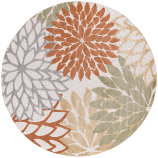 Round outdoor rug featuring a large overlapping floral mandala in orange, sage green, gray and beige on a cream background.