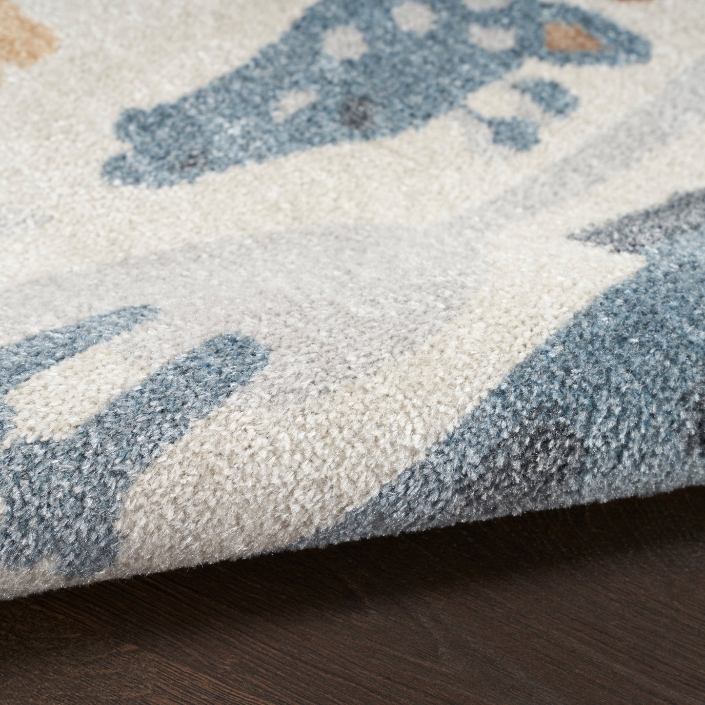 Soft plush runner rug with beige base and blue abstract pattern; close-up shows textured pile and folded edge.