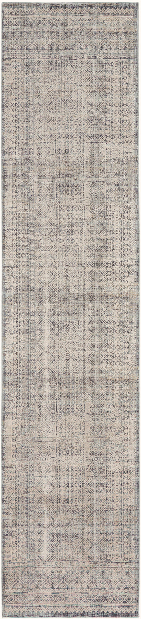 Muted beige and gray distressed rug with geometric patchwork and decorative border.
