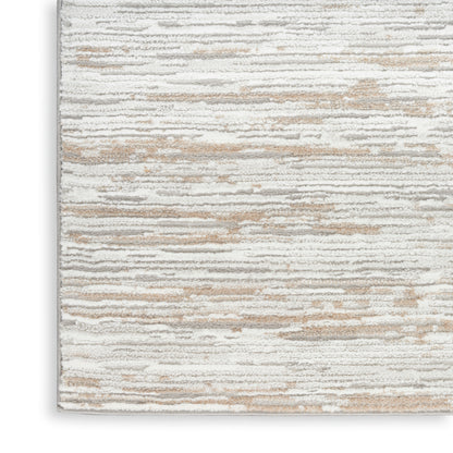 Rectangular area rug in cream, beige and gray with subtle horizontal stripe and soft textured pile.