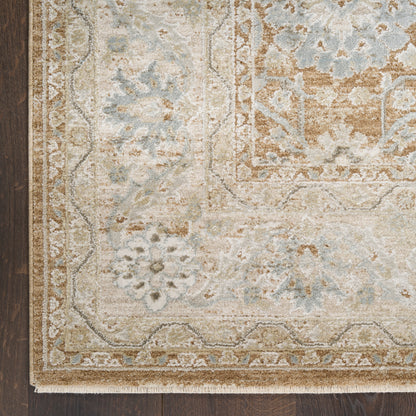 Beige and pale blue oriental area rug with floral motifs and ornate border on dark wood floor.