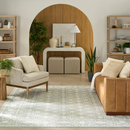 Neutral living room with an arched wooden backdrop, cream console, beige armchair, brown leather sofa, and a patterned rug.