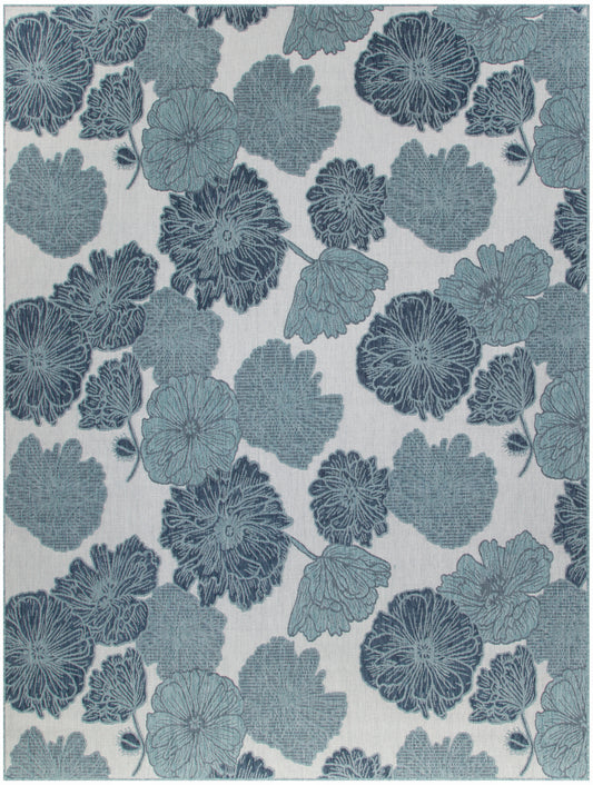 Blue floral jacquard textile pattern with large blossoms and leaves on a light beige background.