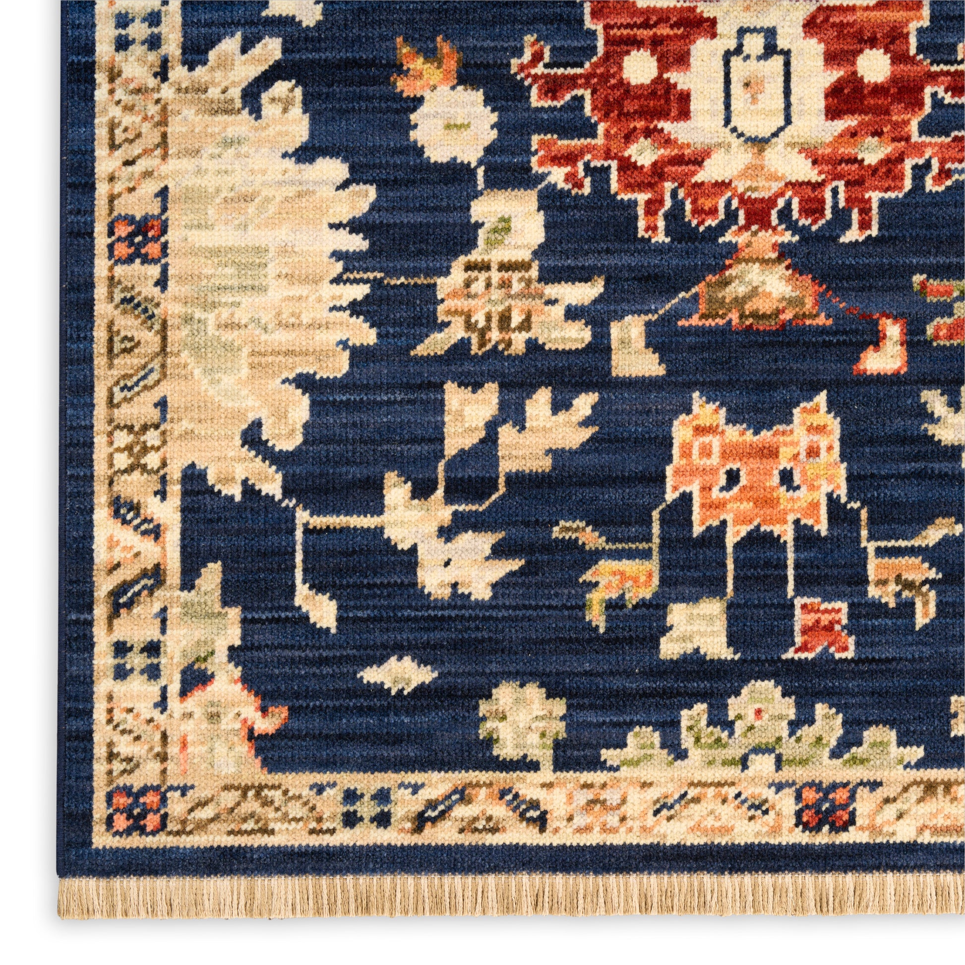 Dark blue oriental rug with ivory and burnt-orange floral motifs, beige patterned border and fringe.