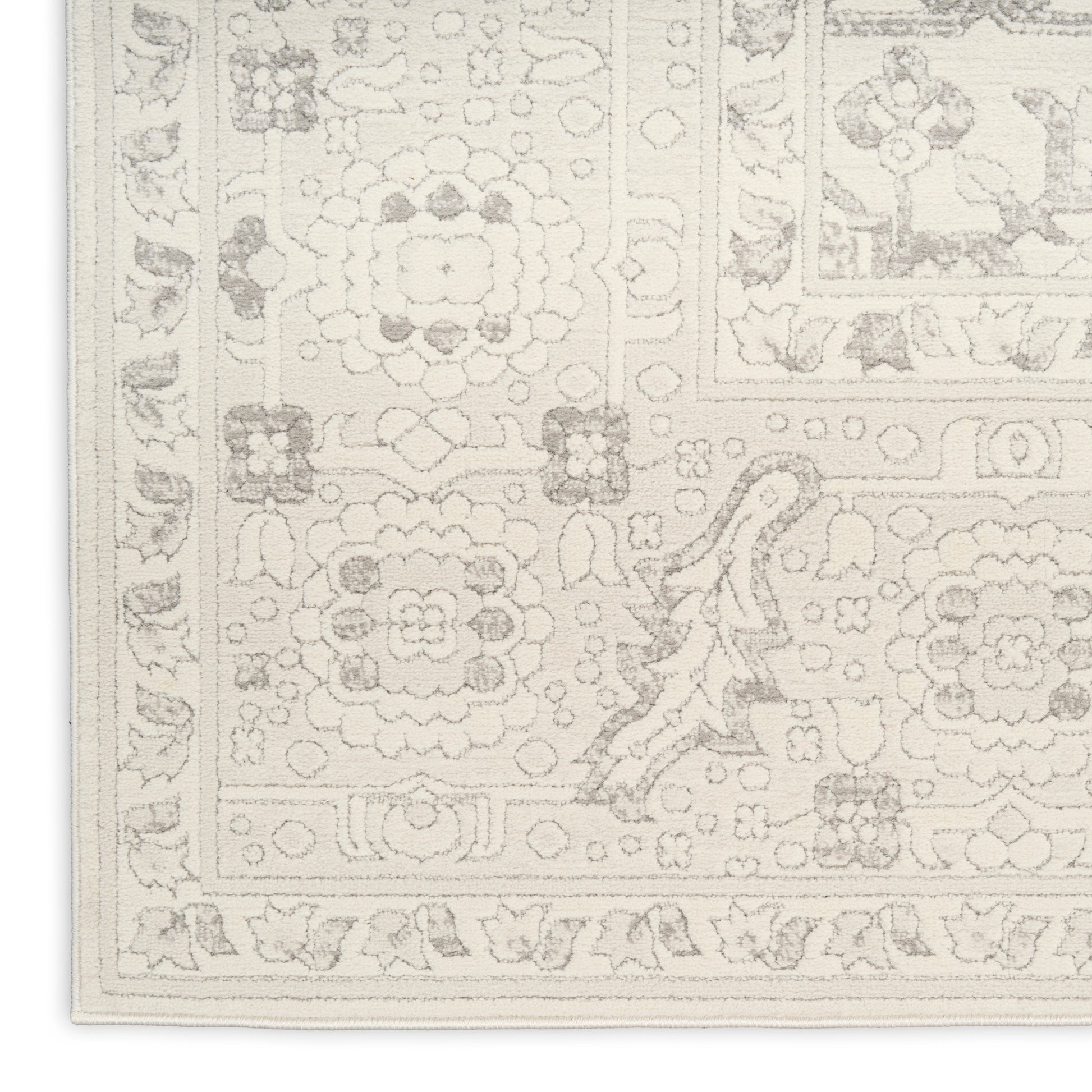 Creamy ivory woven rug with delicate floral border and medallion motifs; traditional oriental-style decor for living spaces.