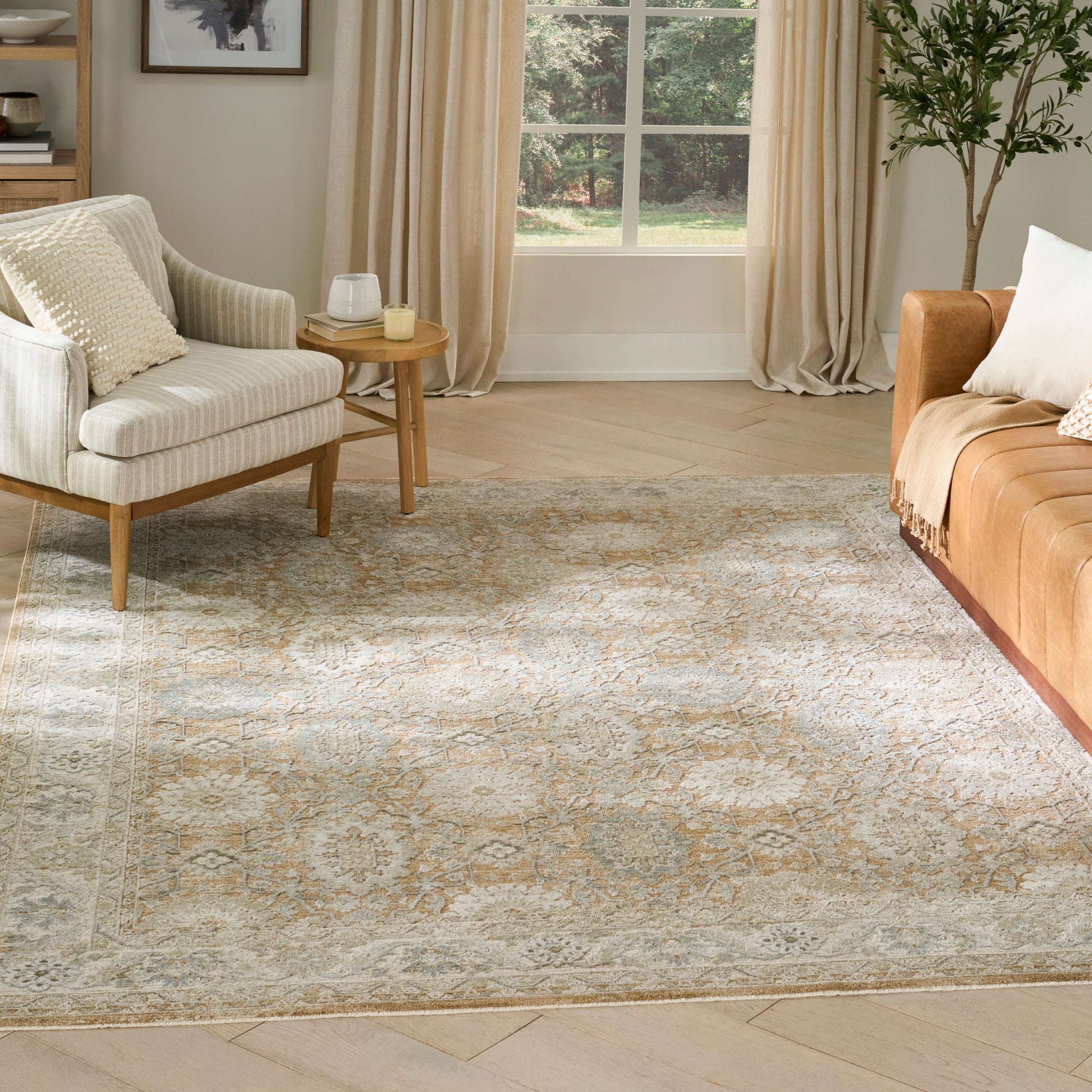 Cozy living room with a beige-blue patterned vintage rug (5' x 8'), cream sofa, orange-brown sofa, wooden side table, and a potted plant.