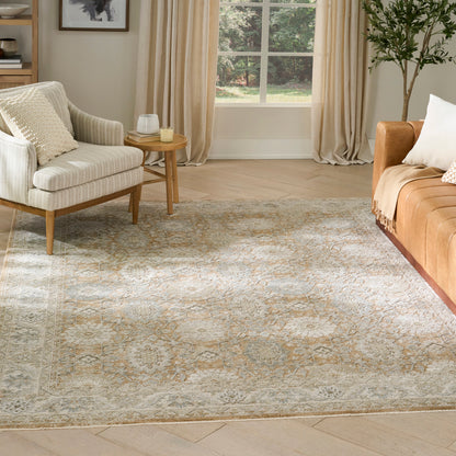 Cozy living room with a beige-blue patterned vintage rug (5' x 8'), cream sofa, orange-brown sofa, wooden side table, and a potted plant.