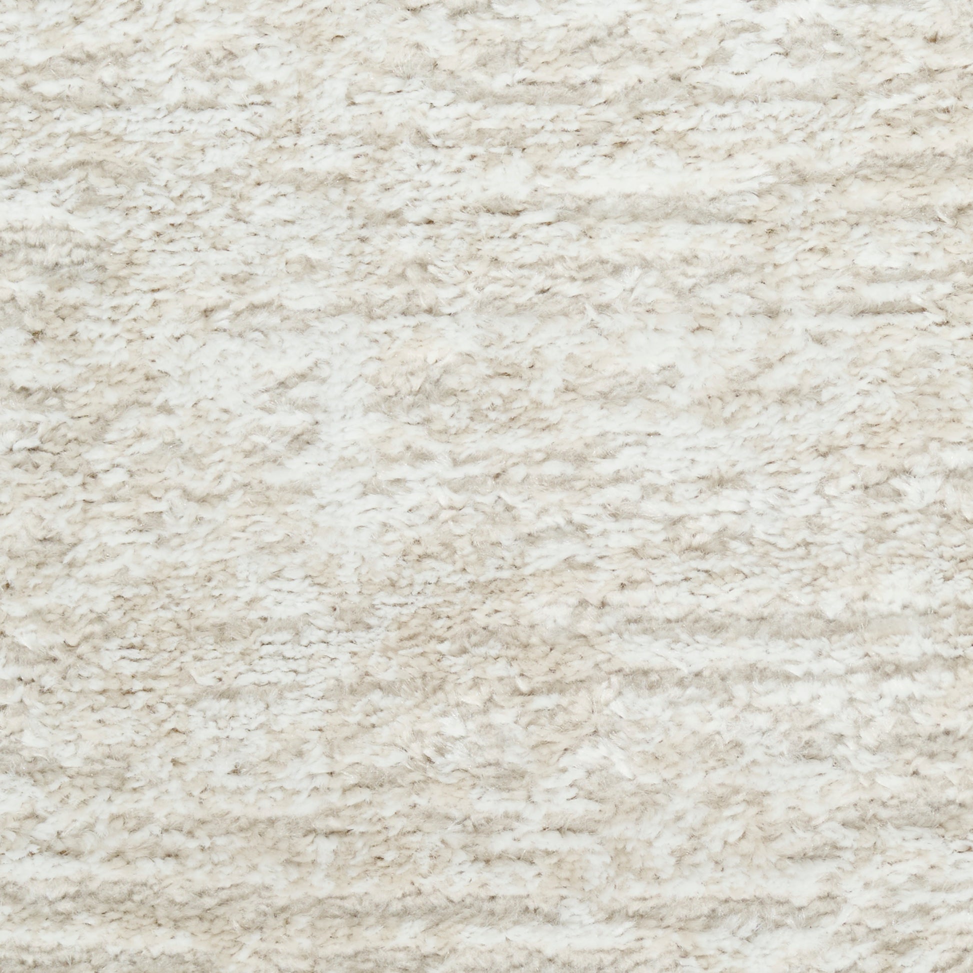 Cream shaggy rug close-up with plush, high-pile fibers and textured surface.