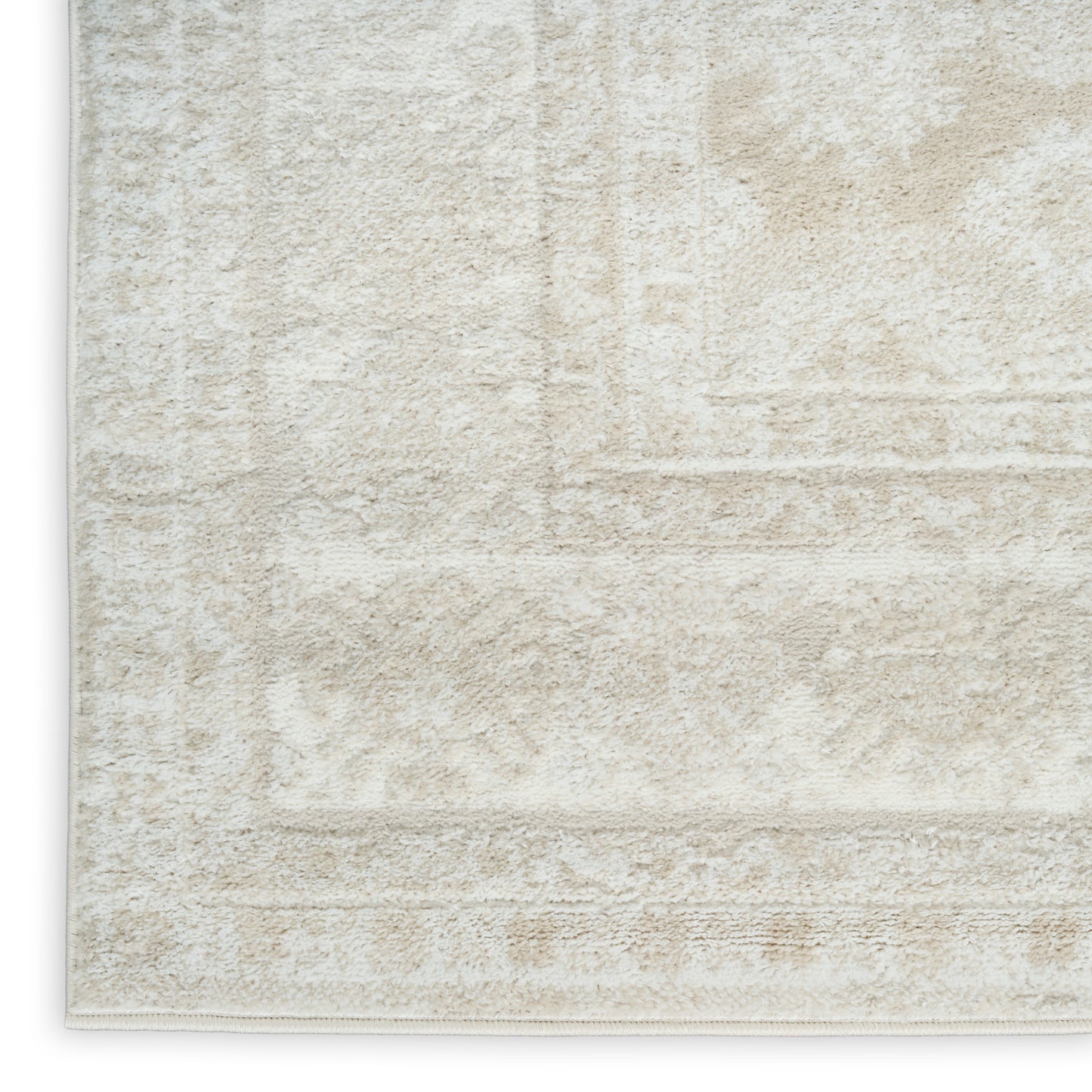 Cream-beige plush area rug with a subtle geometric border and finished edge.