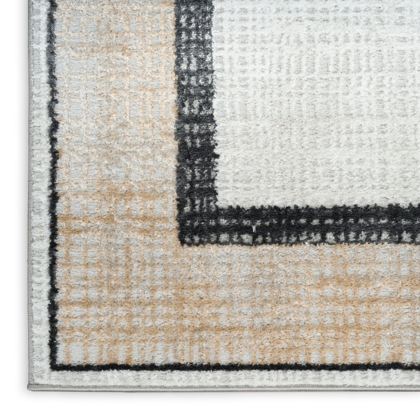 Close-up of a tufted modern geometric area rug in beige, ivory and gray with a black border.