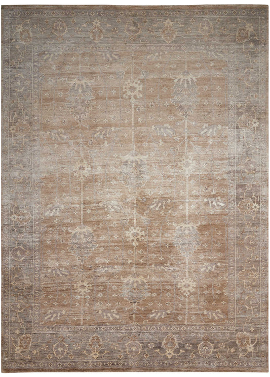 Rectangular distressed vintage-style area rug in muted beige, taupe and gray with faded floral lattice border.