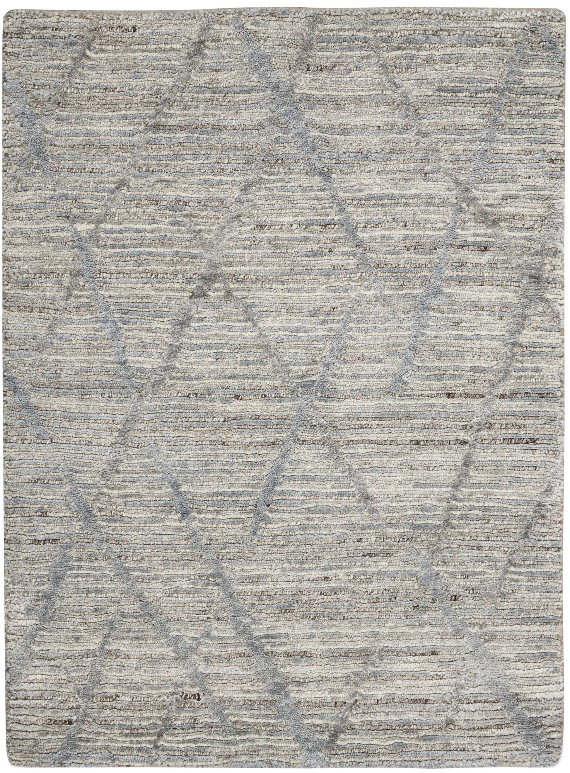 Rectangular beige-gray rug with soft, textured pile and subtle overlapping diamond pattern.
