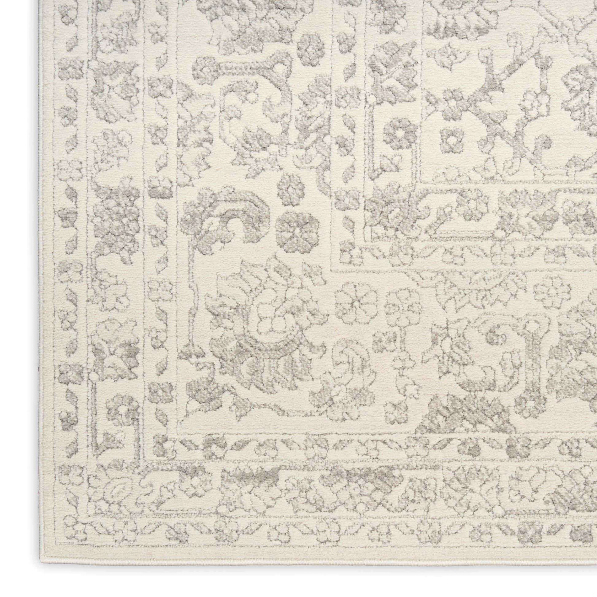 Cream rug with light gray ornate floral pattern and intricate border, oriental-inspired design.