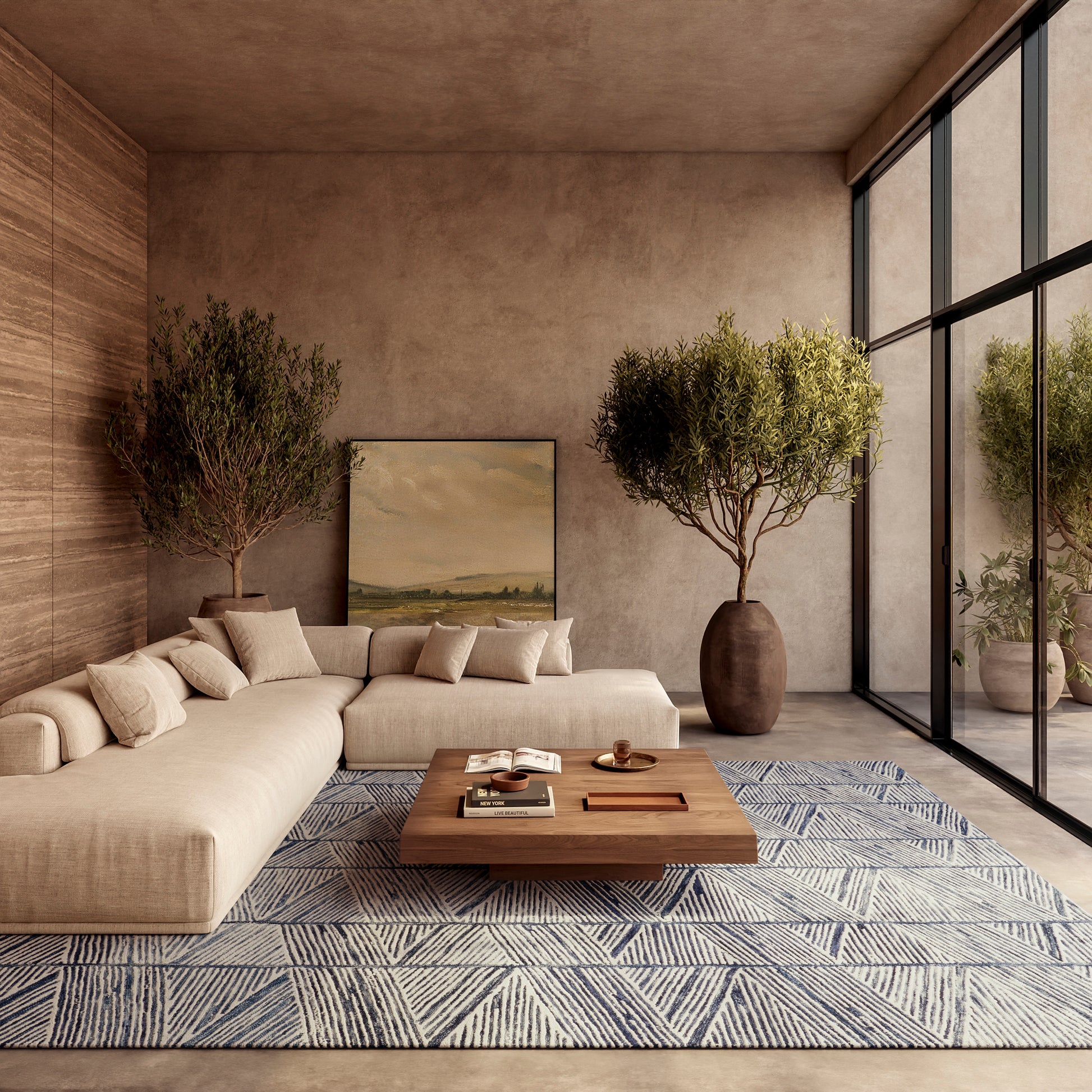 Beige sectional sofa with cushions, wooden coffee table, and a blue geometric rug in a modern living room with potted trees.