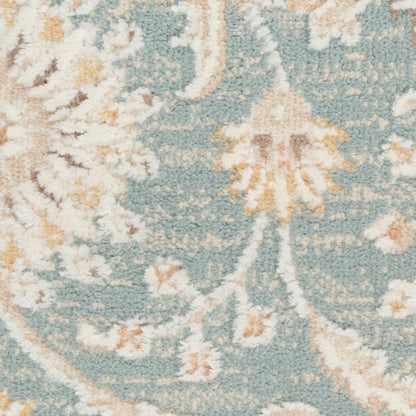 Turquoise rug close-up with ivory floral arabesque pattern and pale gold accents; soft textured pile.