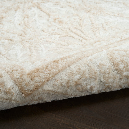 Cream shag rug with soft pile and subtle geometric pattern on dark wood floor.