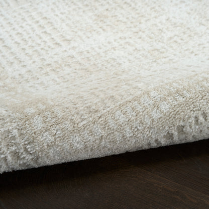 Cream shag rug with dense plush pile on dark wood floor; soft, cozy, modern style.