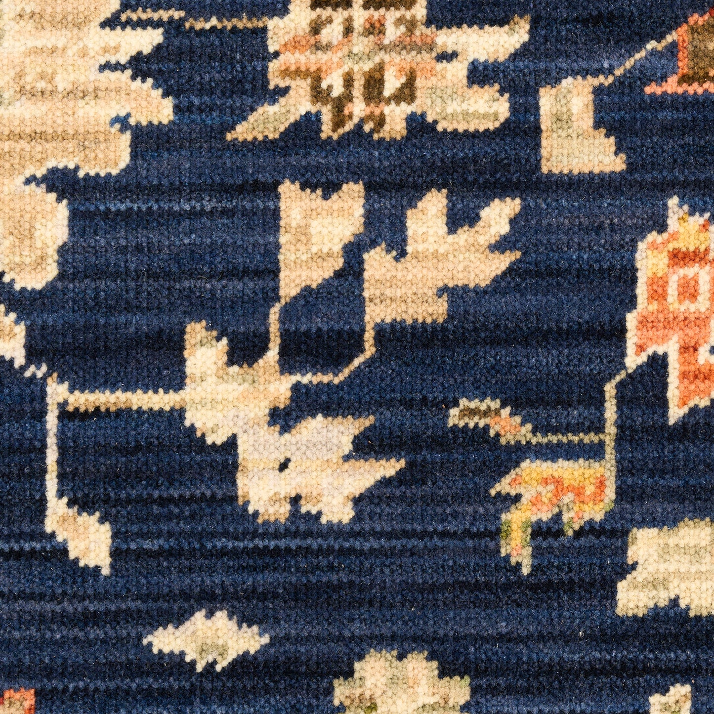Navy blue oriental rug with ivory floral motifs and peach accents; woven textile suitable as an area rug.