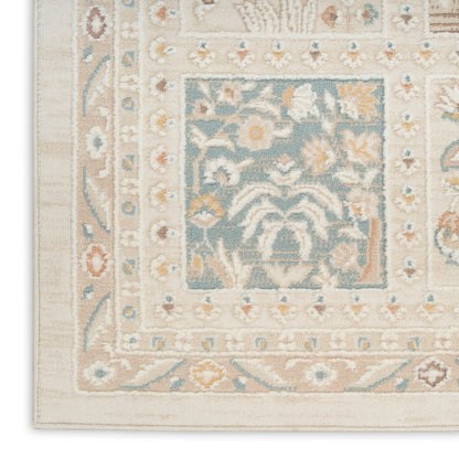 Cream-beige oriental area rug with light blue central panel, floral motifs and decorative border in traditional Persian-inspired style.