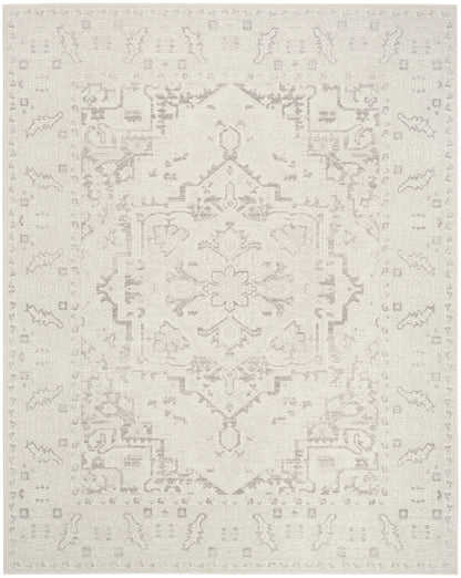 Ivory distressed oriental rug with a subtle beige central medallion and floral border; area rug.