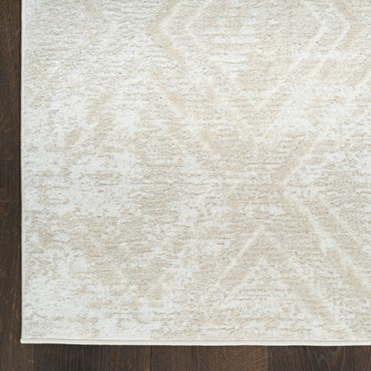Cream textured rug with subtle geometric pattern in ivory tones, plush pile on dark wood floor.