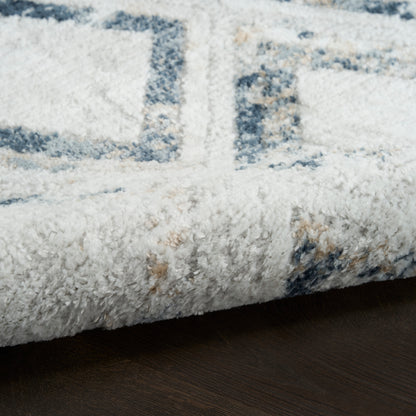 Plush white shag rug with blue geometric pattern on dark wooden floor