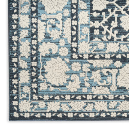 Blue and ivory Persian-inspired area rug corner with floral motifs and geometric border.