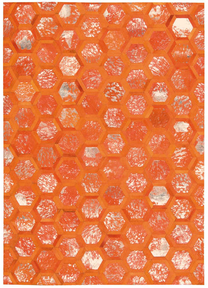 Bright orange hexagonal honeycomb rug pattern with white distressed specks; bold geometric modern rug design.