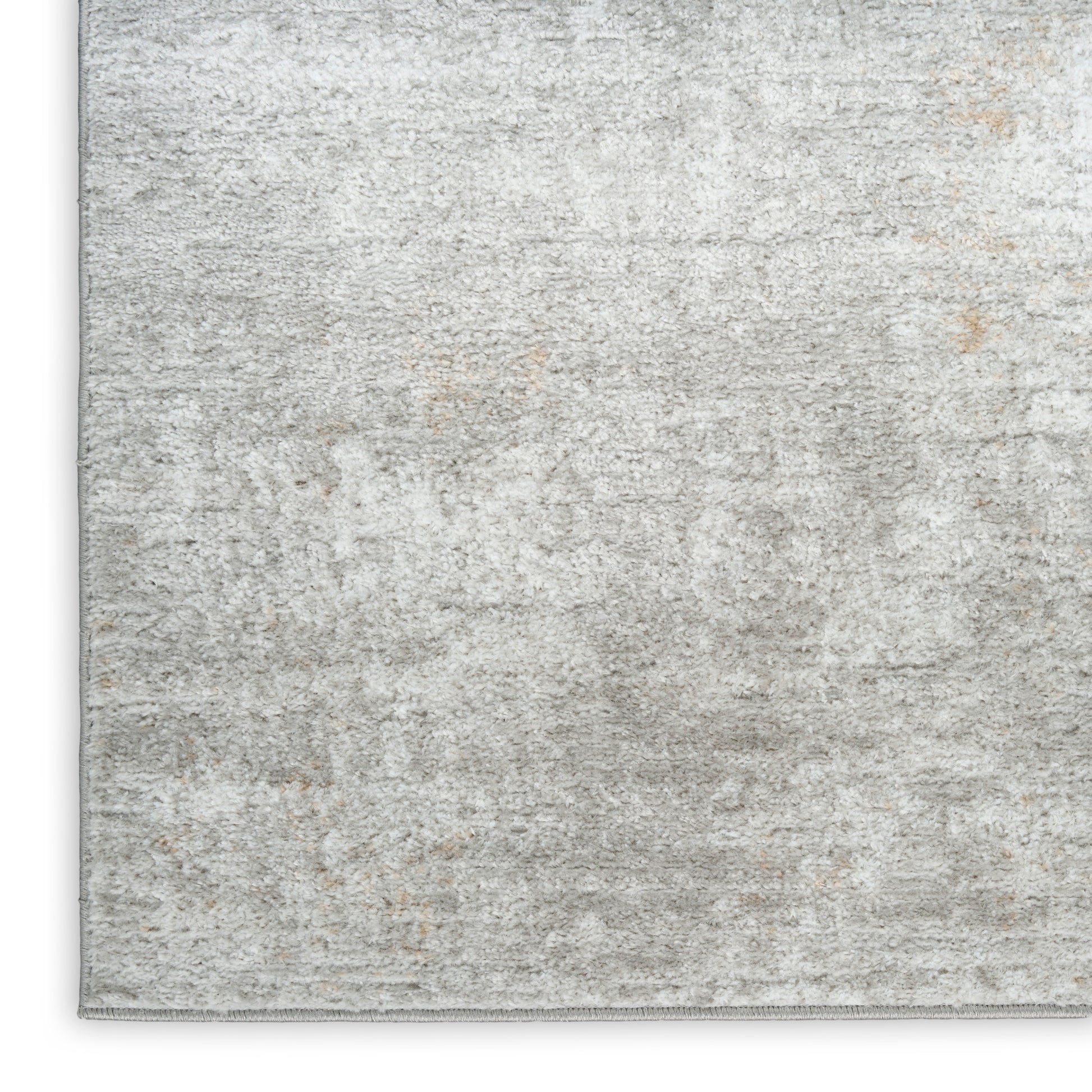 Soft gray distressed area rug with subtle beige patches; low-pile, rectangular, cozy modern living room style.