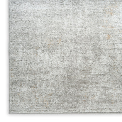Soft gray distressed area rug with subtle beige patches; low-pile, rectangular, cozy modern living room style.