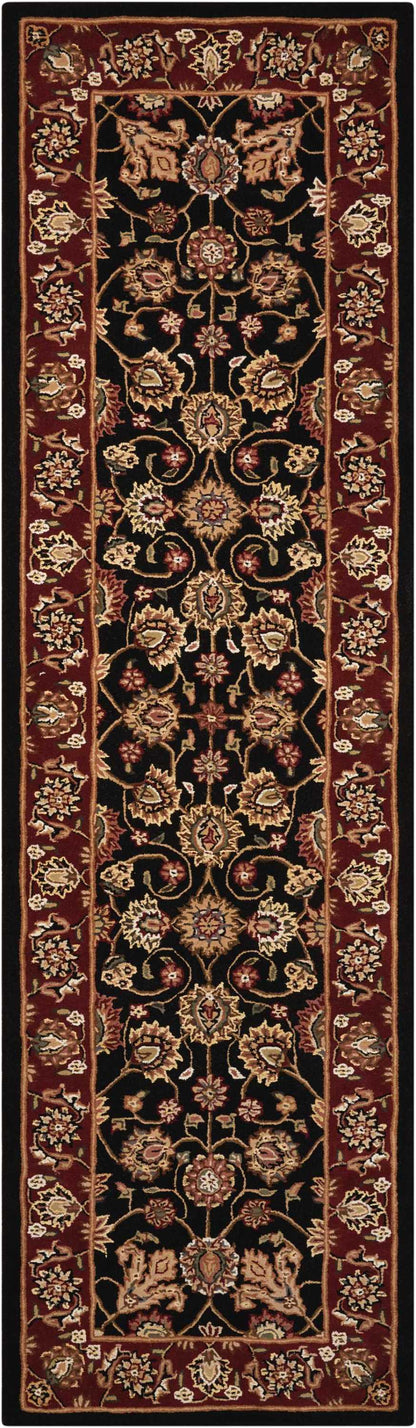 Persian-style long runner rug with black central field, gold and pink floral vines, ornate red borders.