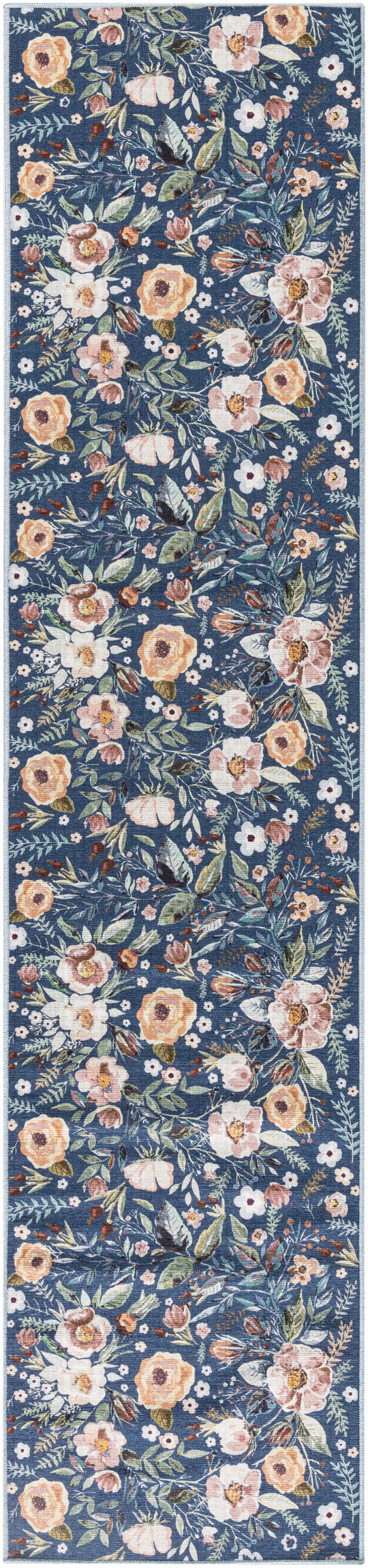Floral patterned runner rug on blue background with peach & pink & white flowers and green leaves.
