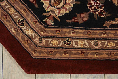 Corner view of oriental rug: dark navy field with floral motifs, cream/beige layered borders, maroon outer trim on light wooden floor.