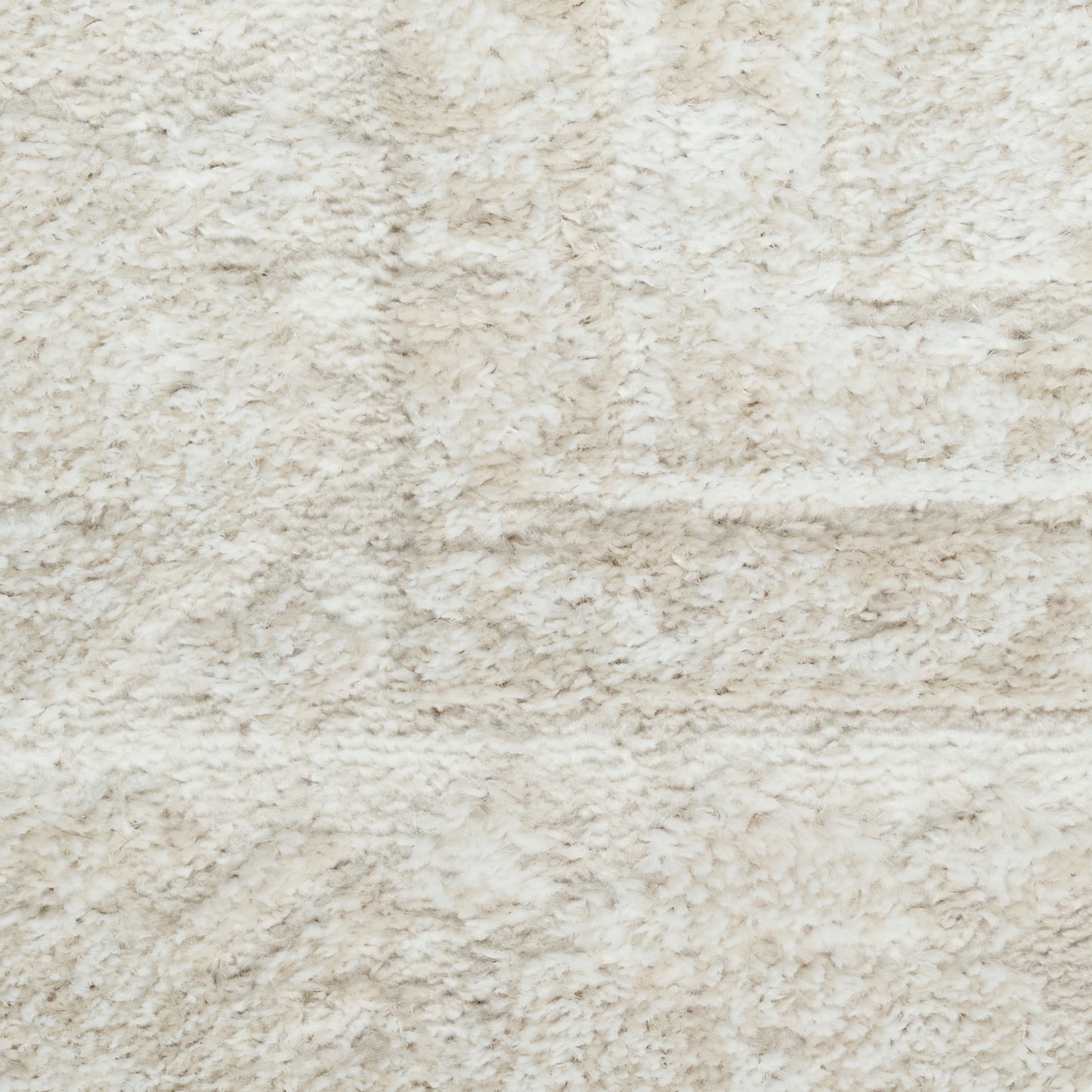Cream shaggy rug close-up with plush beige fibers, soft texture for living room decor.