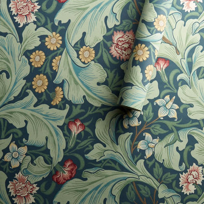Morris & Co. Leicester Wallpaper in Woad/Sage featuring elegant arching leaves and mid-scale floral blooms designed by John Henry Dearle in 1912. Inspired by the Bachelors Button pattern, this Arts & Crafts designer wallpaper is ideal for feature walls, living rooms, bedrooms, dining rooms, hallways, English cottage, traditional, vintage, and heritage-inspired interiors.
