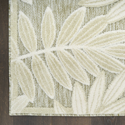 Rectangular ivory leaf-patterned tufted rug on beige background with textured pile; dark wood floor edge