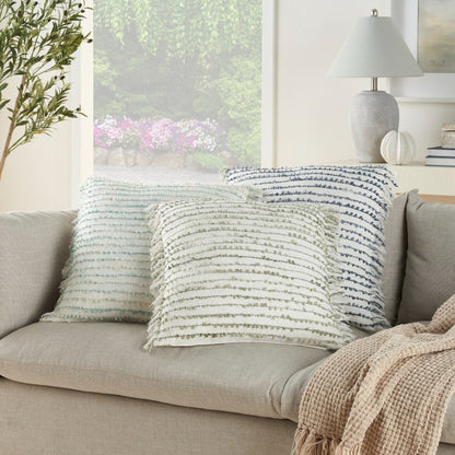 A handcrafted 20x20 aqua blue Mina Victory throw pillow with a textured boucle stripe pattern, soft ombré color variation, and decorative crimped fringe on both sides. Made from a cotton blend with a linen-like texture and a plush polyester insert, this contemporary coastal throw pillow adds color and texture to sofas, accent chairs, beds, living rooms, bedrooms, beach houses, and modern home décor.
