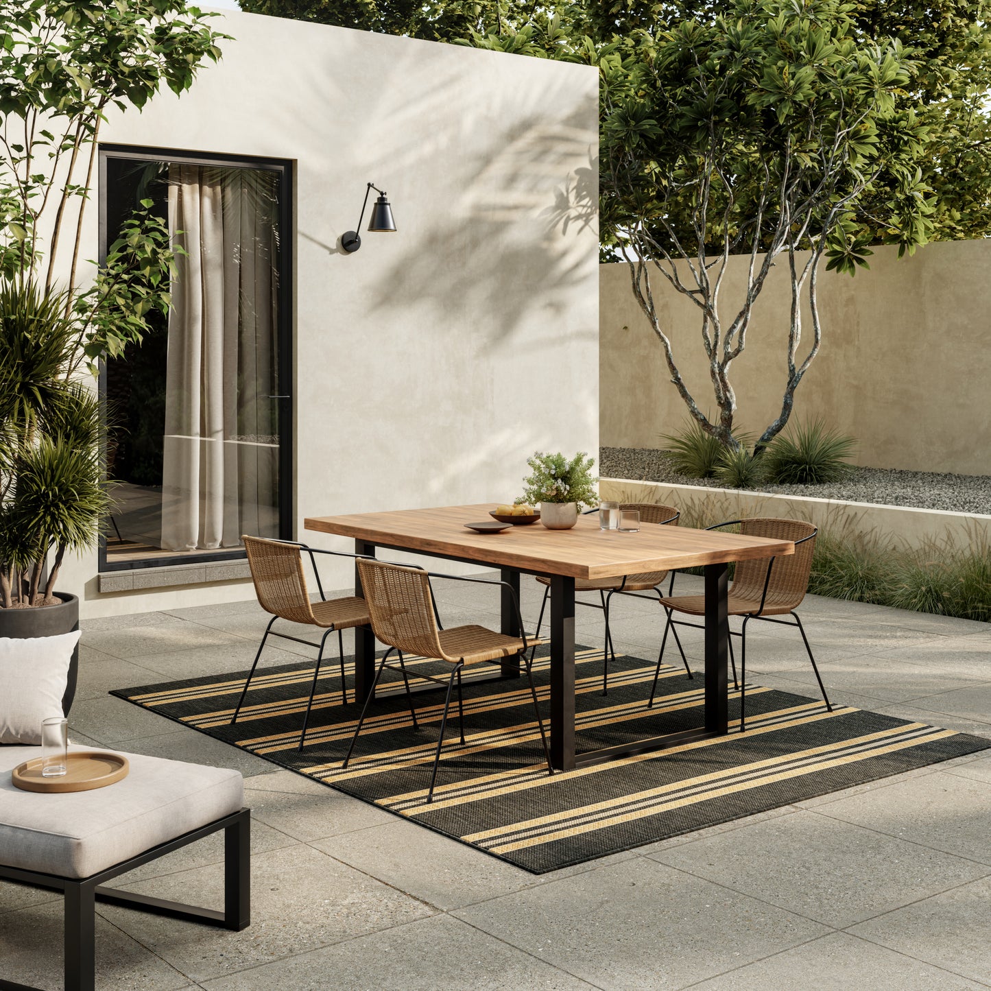 Modern outdoor rug on patio with a striped beige pattern.