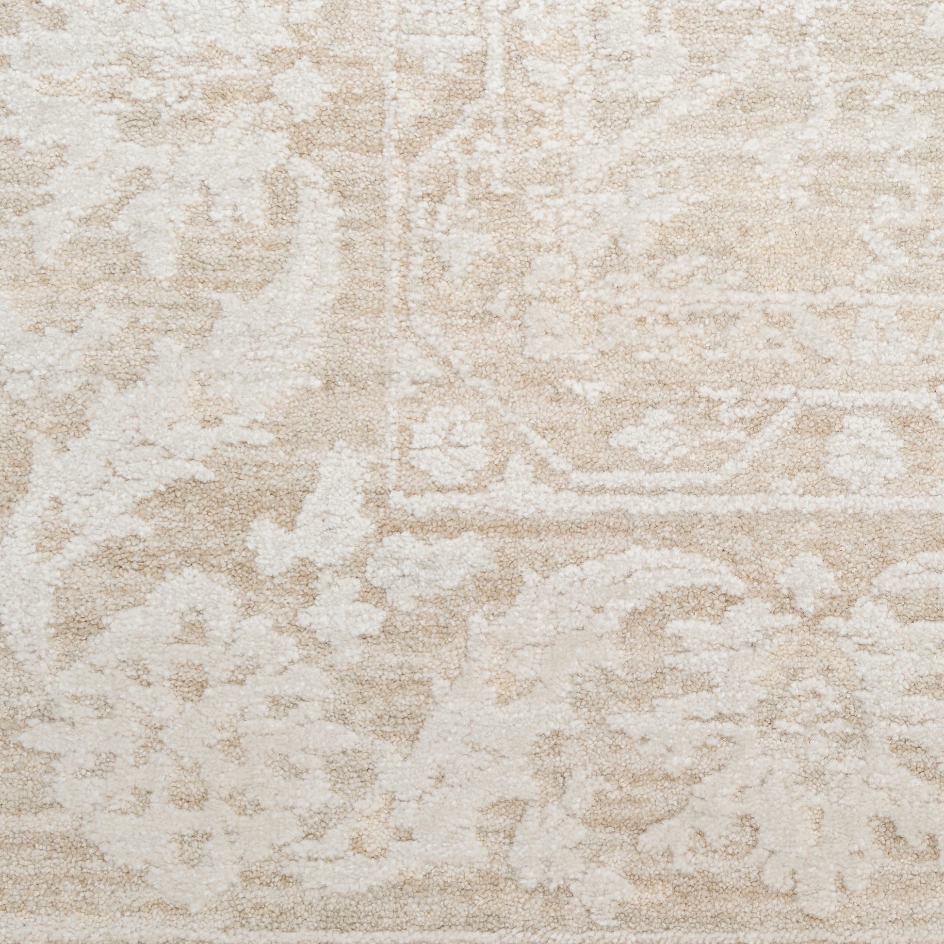 Beige and cream distressed oriental rug with floral medallion pattern and subtle border.