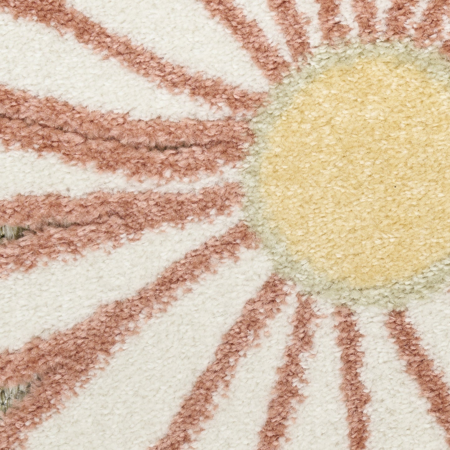 Soft tufted rug featuring a yellow sun center and pink rays on a cream background.