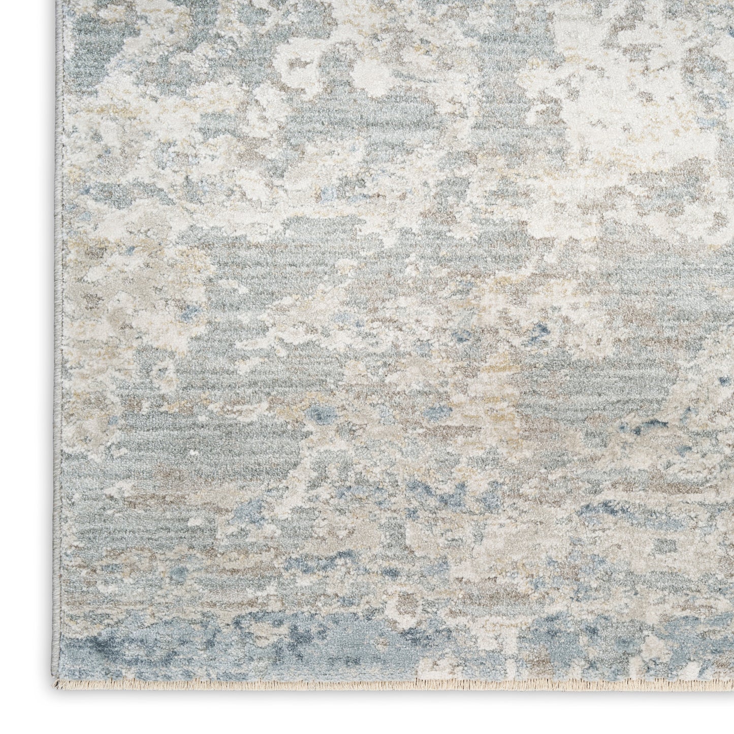 Rectangular area rug in blue-gray and beige with a distressed abstract pattern; plush, modern coastal style.
