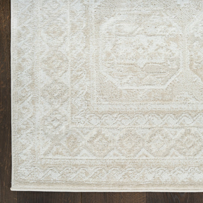 Ivory textured area rug with subtle geometric motifs and a diamond border; plush pile on dark wood floor.